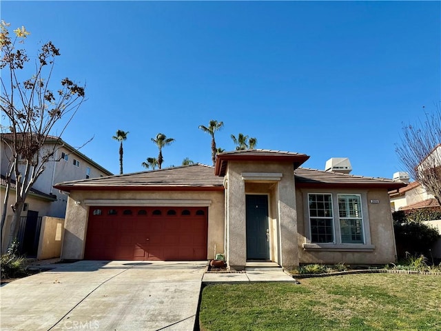 view of front of home with a garage and a front yard