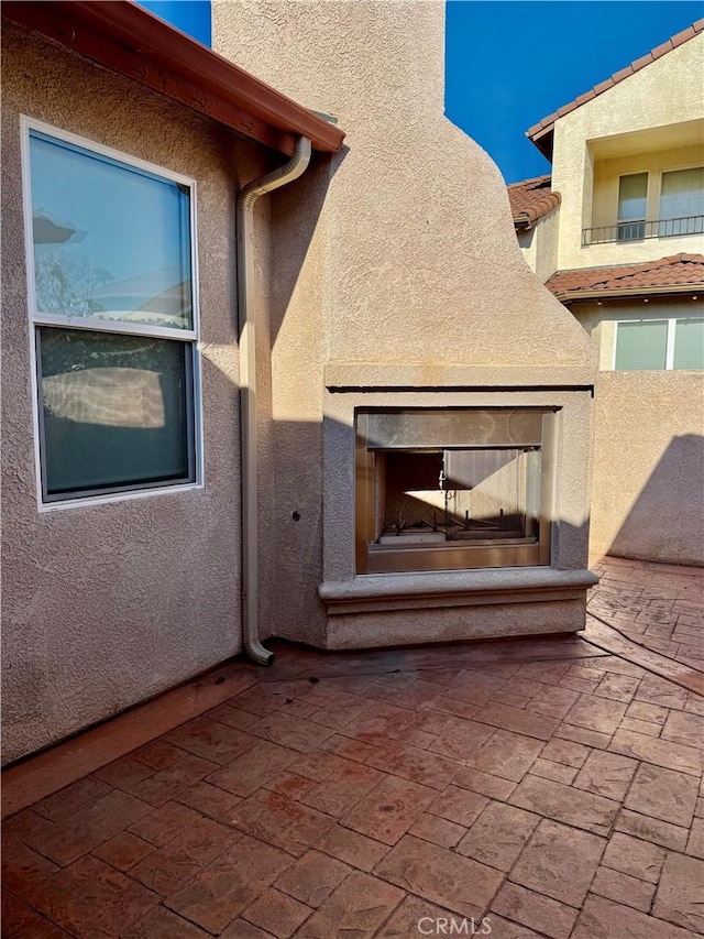 view of patio featuring a multi sided fireplace