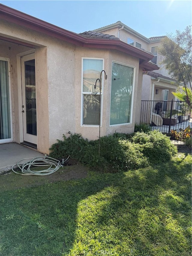 view of property exterior with a yard