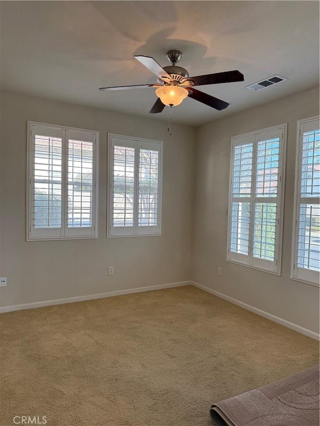 spare room featuring carpet flooring and ceiling fan