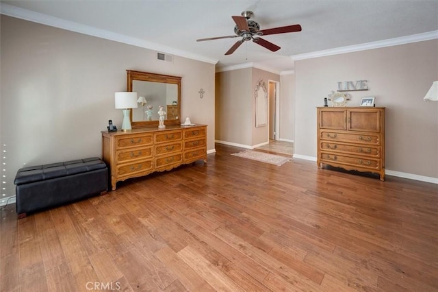 bedroom with crown molding, wood-type flooring, and ceiling fan