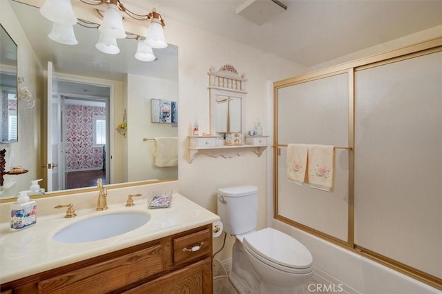 full bathroom with shower / bath combination with glass door, vanity, and toilet