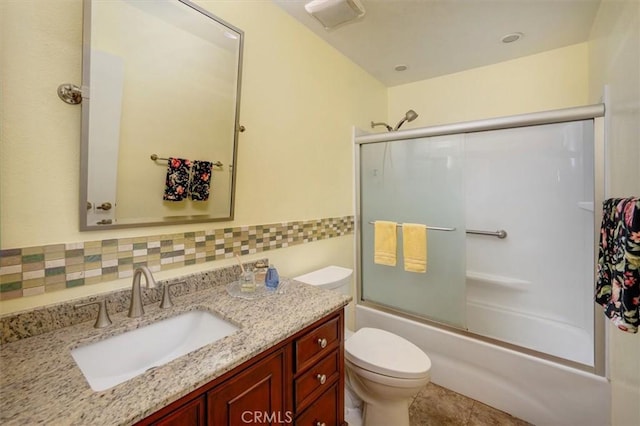 full bathroom with toilet, vanity, and shower / bath combination with glass door