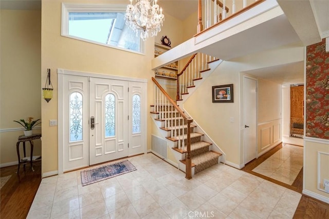 entryway featuring a chandelier and a high ceiling