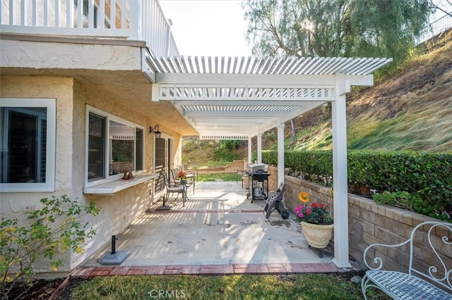 view of patio with a grill and a pergola