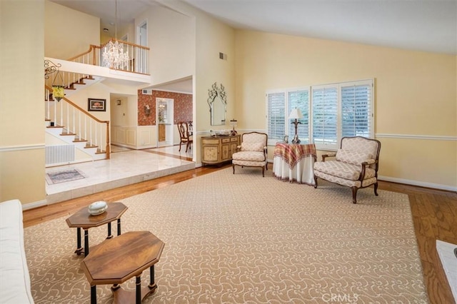 living room with hardwood / wood-style flooring and high vaulted ceiling