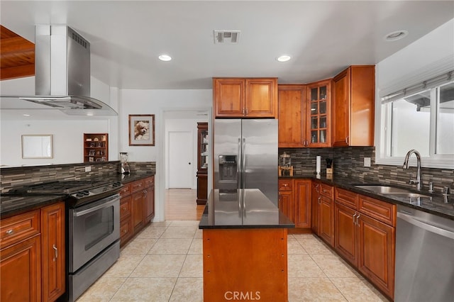 kitchen with appliances with stainless steel finishes, island range hood, sink, a center island, and light tile patterned floors