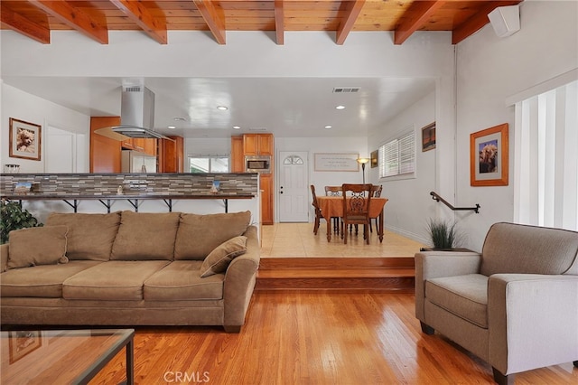 living room with beam ceiling, light wood-type flooring, and wooden ceiling