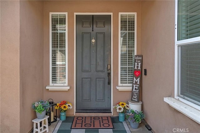 doorway to property with stucco siding