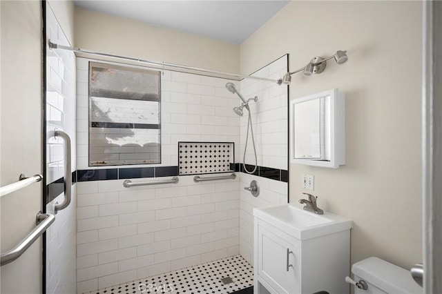 bathroom featuring vanity, a shower with door, and toilet