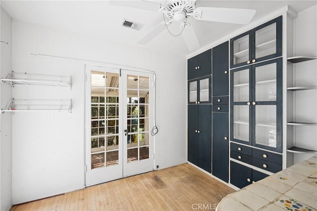 doorway to outside with wood-type flooring and ceiling fan