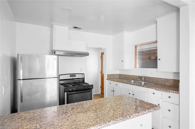 kitchen featuring sink, stainless steel fridge, range hood, white cabinets, and gas range