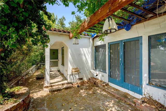 view of side of property with a pergola and a patio area