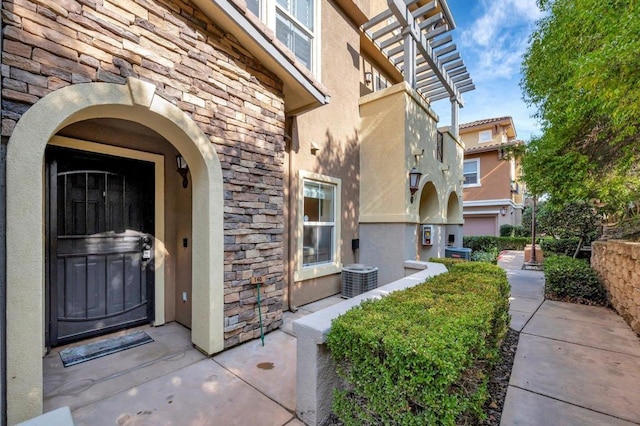 doorway to property featuring central AC