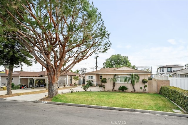 single story home featuring a carport and a front yard