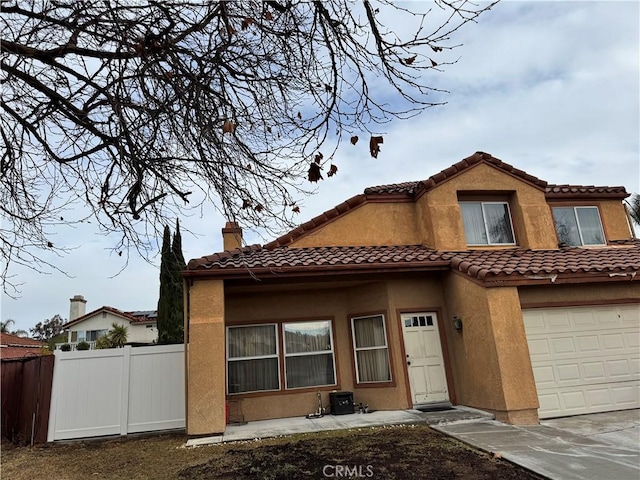 mediterranean / spanish-style house with a garage