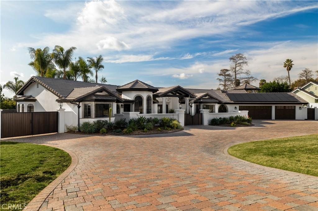 view of front of home featuring a garage and solar panels