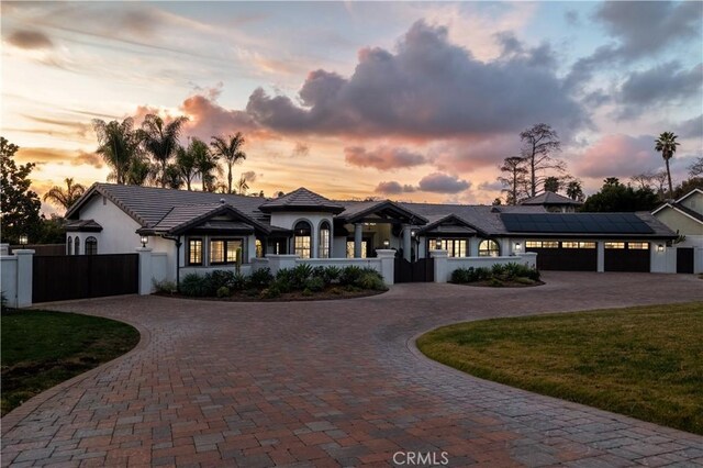 view of front of house with a garage and a lawn