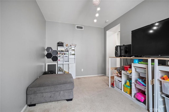 sitting room featuring light colored carpet