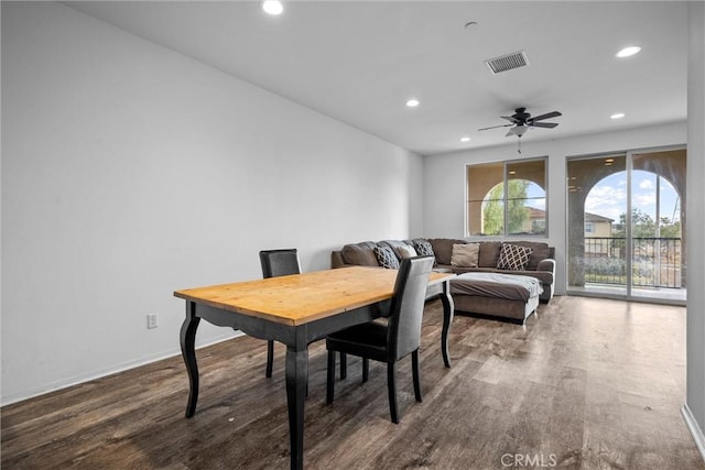 dining space featuring dark wood-type flooring and ceiling fan