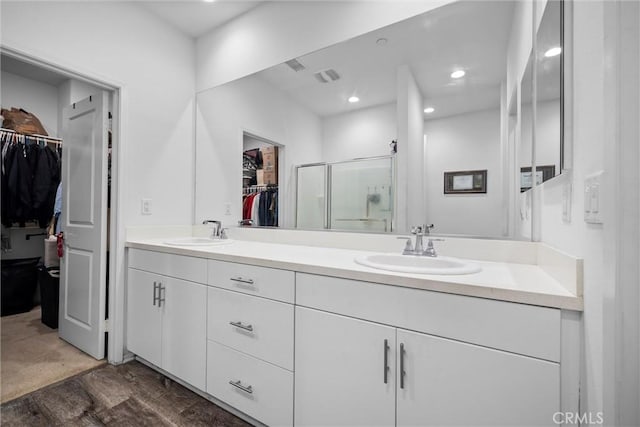 bathroom featuring vanity, wood-type flooring, and a shower with door