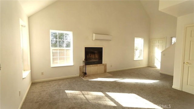 unfurnished living room featuring light colored carpet, a wall mounted air conditioner, a tiled fireplace, and high vaulted ceiling