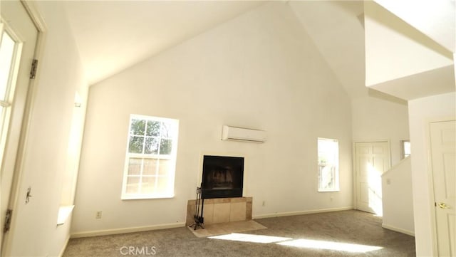 unfurnished living room with a fireplace, a wall mounted AC, high vaulted ceiling, and light carpet