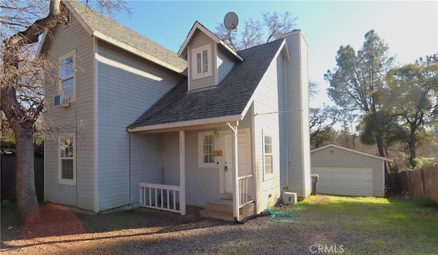 exterior space featuring a garage and an outbuilding