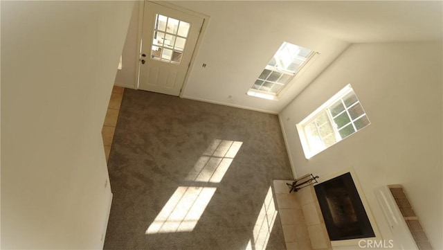 unfurnished living room with dark colored carpet and vaulted ceiling