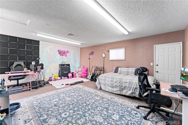 bedroom with carpet and a textured ceiling