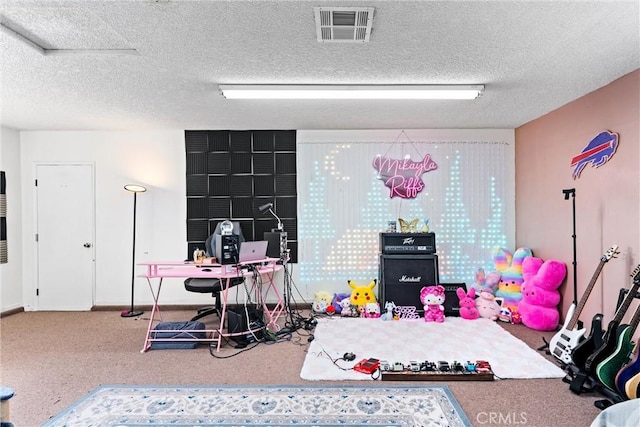 recreation room with carpet floors and a textured ceiling