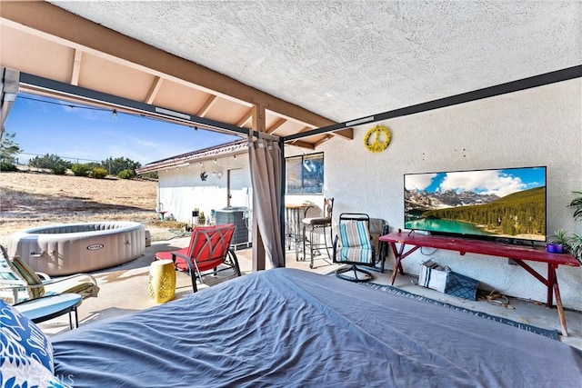 view of patio featuring a hot tub, an outdoor bar, and central AC unit