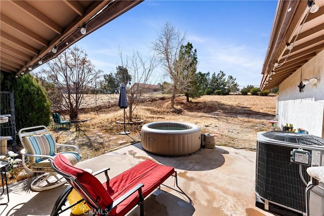 view of patio featuring central AC unit and a rural view