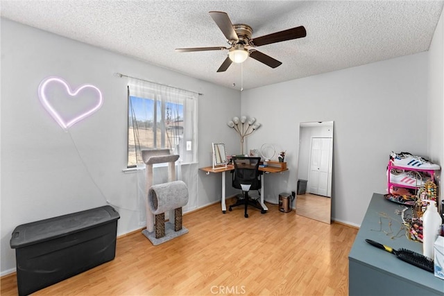 office with wood-type flooring, ceiling fan, and a textured ceiling