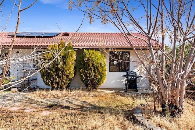 back of house with solar panels