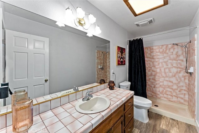 bathroom featuring vanity, curtained shower, toilet, and hardwood / wood-style flooring