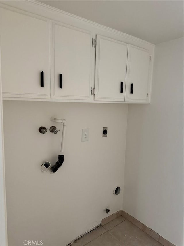 laundry room with light tile patterned flooring, gas dryer hookup, cabinets, washer hookup, and hookup for an electric dryer