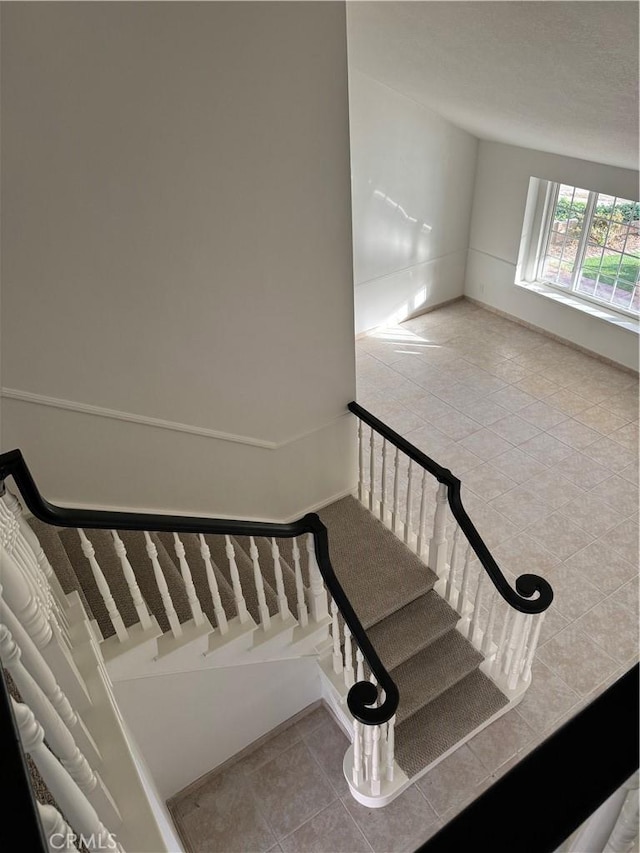 stairway with tile patterned flooring