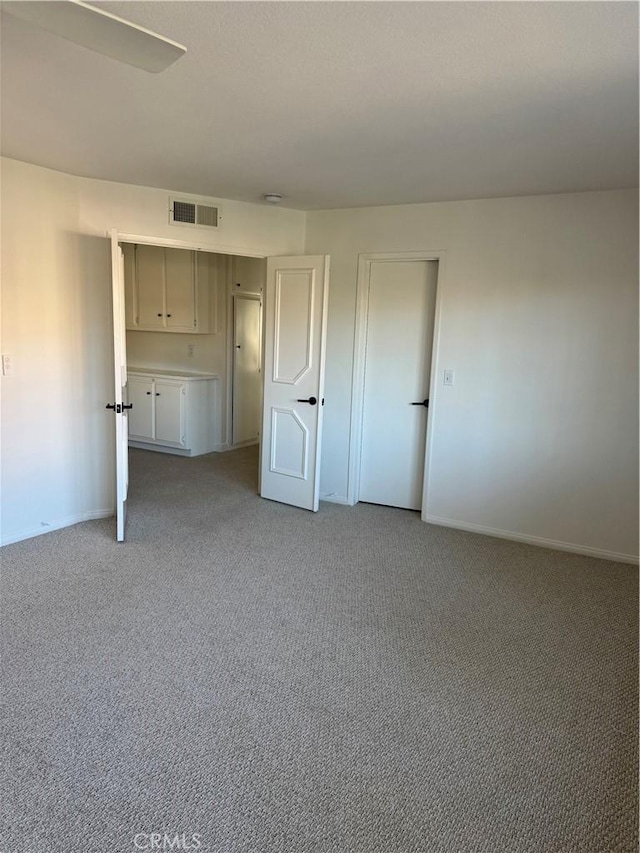 unfurnished bedroom featuring carpet