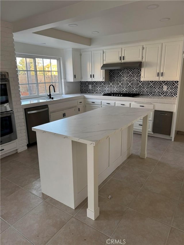 kitchen with white cabinetry, dishwashing machine, sink, and a kitchen island