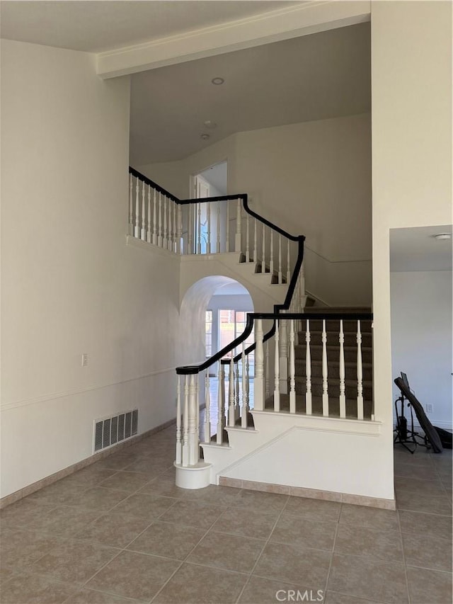 stairs with tile patterned floors