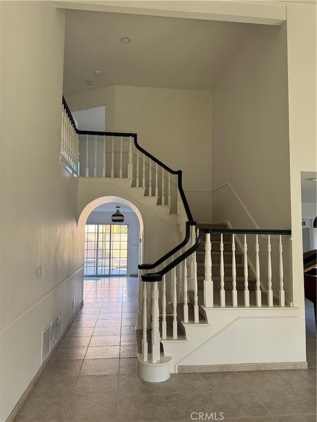 staircase featuring tile patterned flooring