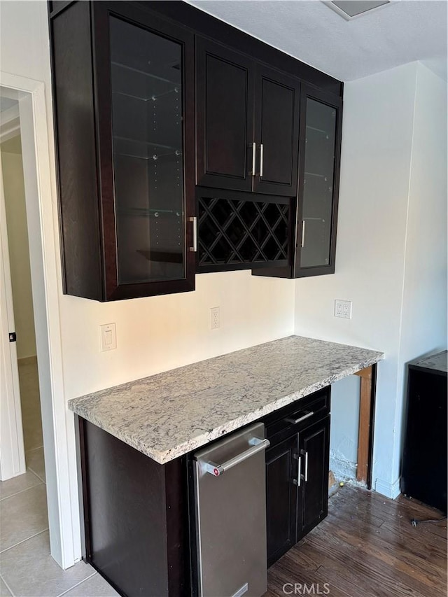 interior space with light stone counters and hardwood / wood-style floors