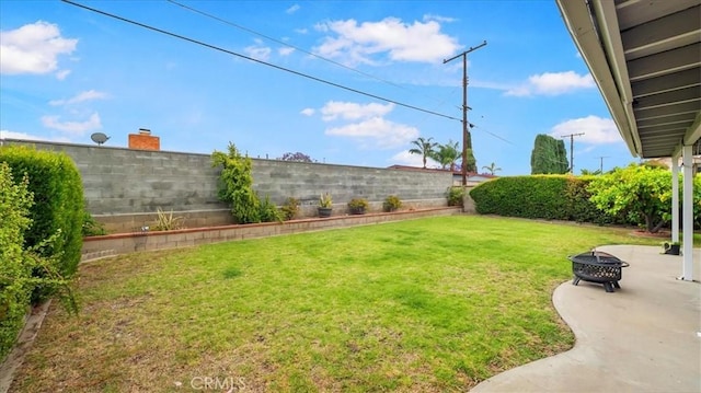 view of yard with a fire pit and a patio area