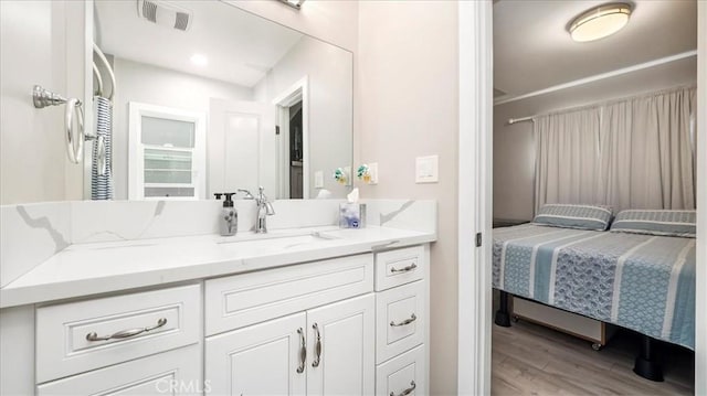 bathroom with vanity and hardwood / wood-style flooring