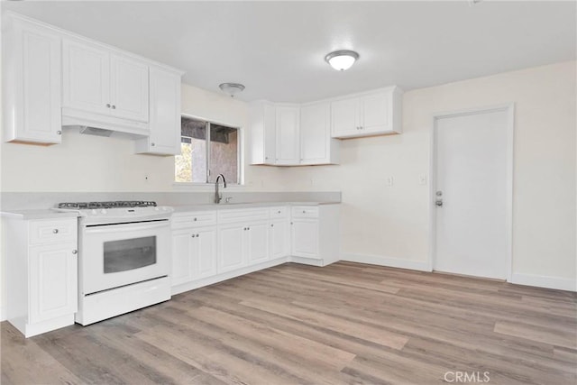 kitchen with white cabinetry, white gas range, sink, and light wood-type flooring