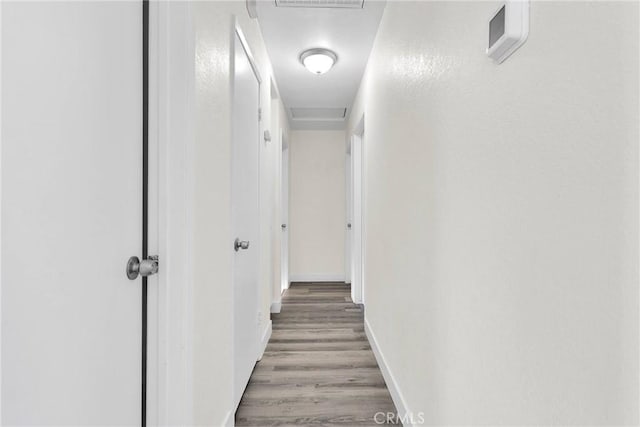 hall with hardwood / wood-style floors