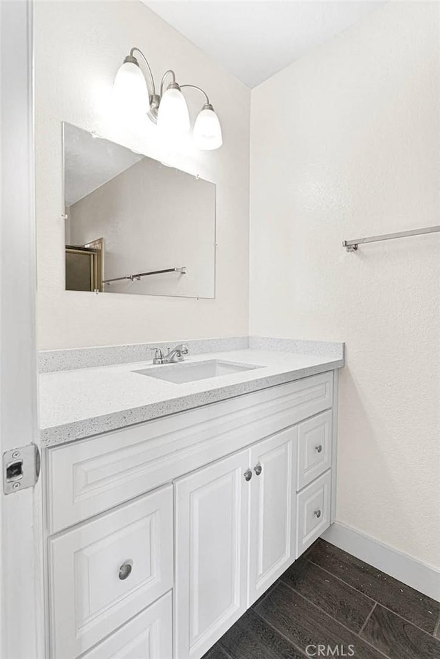 bathroom featuring vanity and hardwood / wood-style floors