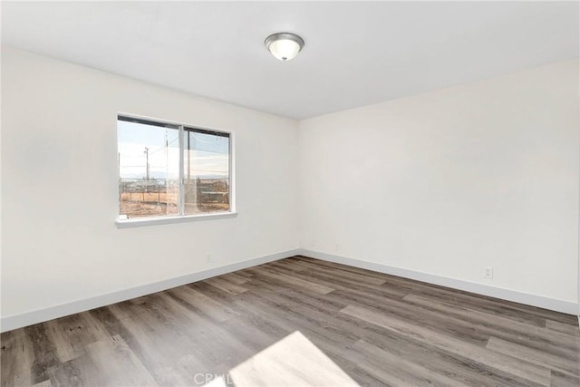 spare room with hardwood / wood-style flooring