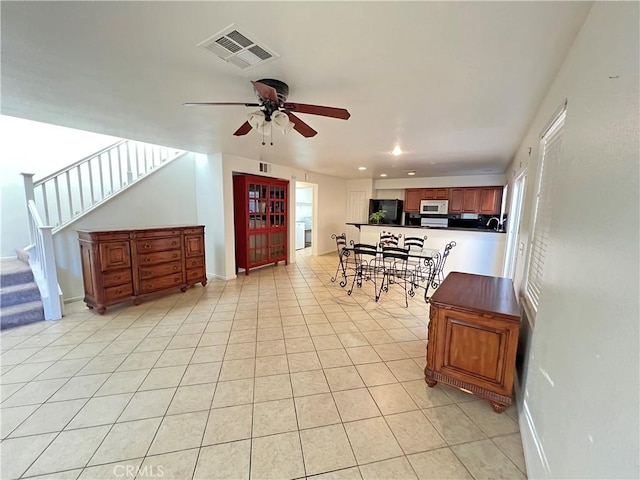 tiled dining room with ceiling fan